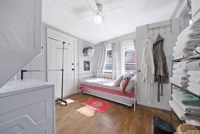 interior space with hardwood / wood-style floors, ceiling fan, lofted ceiling, and a textured ceiling