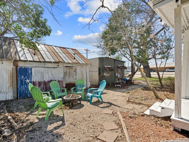 view of yard with a fire pit