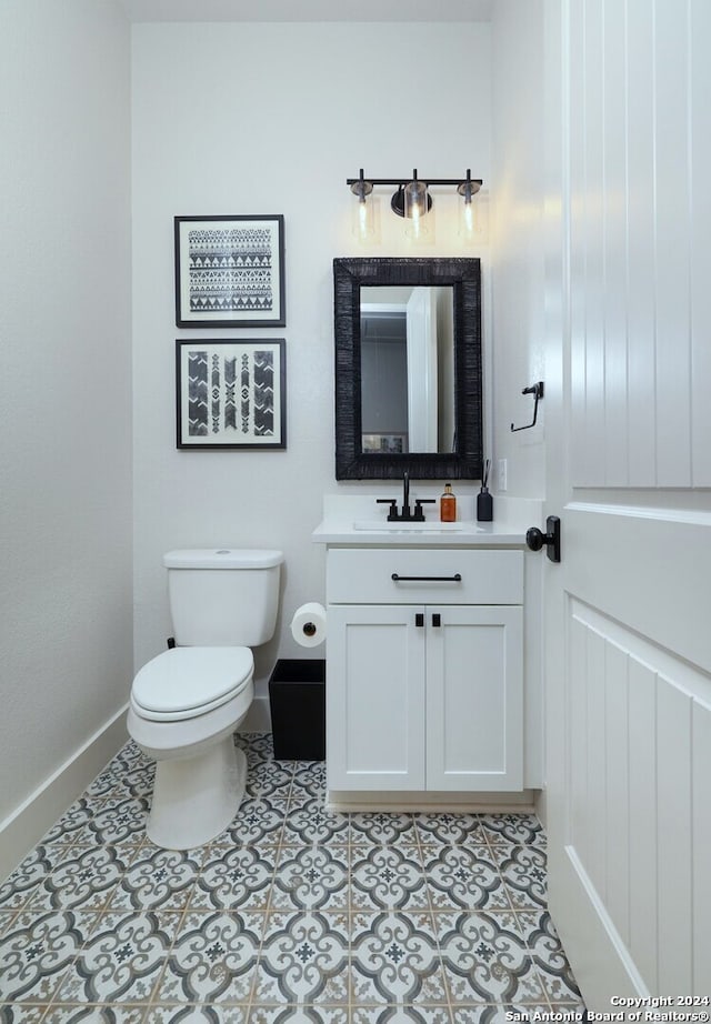 bathroom with tile patterned floors, vanity, and toilet