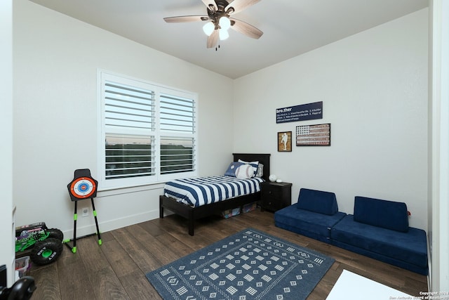 bedroom with dark hardwood / wood-style flooring and ceiling fan