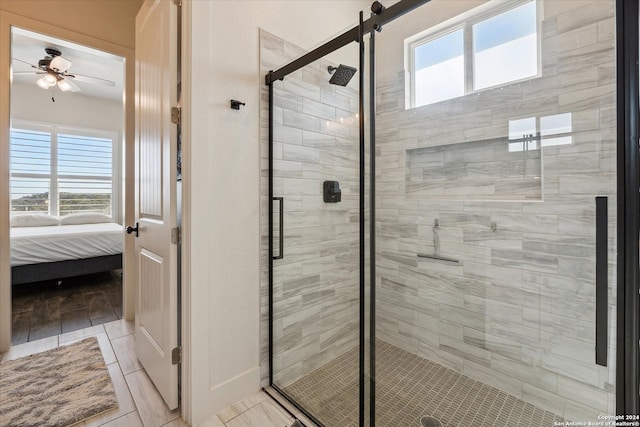 bathroom featuring ceiling fan and walk in shower