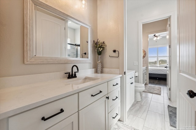 bathroom featuring ceiling fan, tile patterned flooring, vanity, and toilet