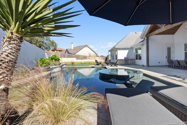 view of swimming pool with a patio area and area for grilling