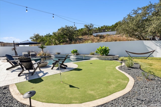 view of yard featuring a patio area and a fenced in pool