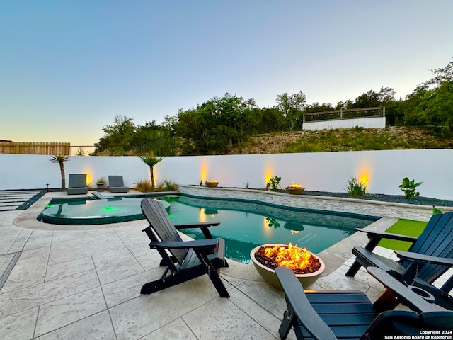 pool at dusk with a patio