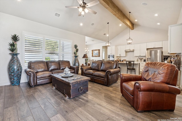 living room featuring hardwood / wood-style floors, ceiling fan, beam ceiling, and high vaulted ceiling