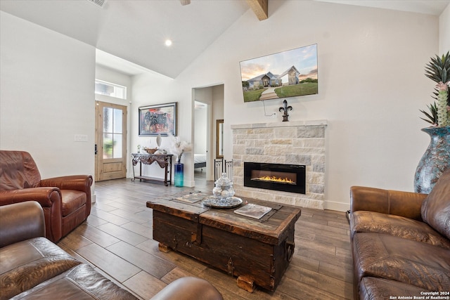 living room featuring beam ceiling, a stone fireplace, high vaulted ceiling, and hardwood / wood-style flooring