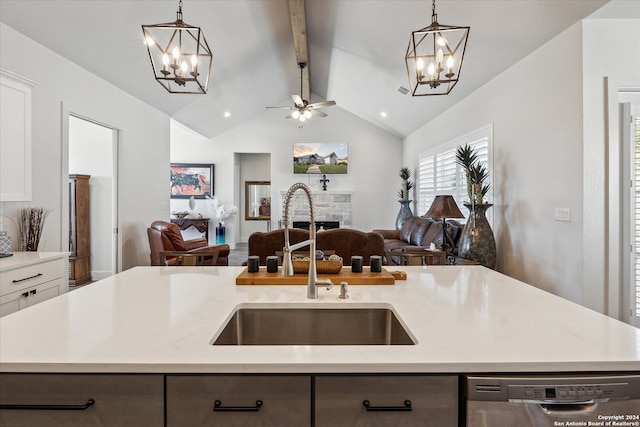 kitchen featuring dishwasher, sink, hanging light fixtures, an island with sink, and white cabinetry