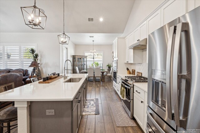 kitchen with white cabinets, a wealth of natural light, sink, and appliances with stainless steel finishes