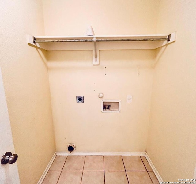 6050 Lakefront, San Antonio, TX 78222 - washroom with hookup for an electric dryer, baseboards, washer hookup, light tile patterned floors, and gas dryer hookup
