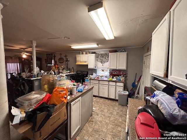 kitchen with white cabinets and black range with electric cooktop