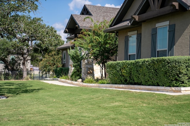 view of side of property with a yard