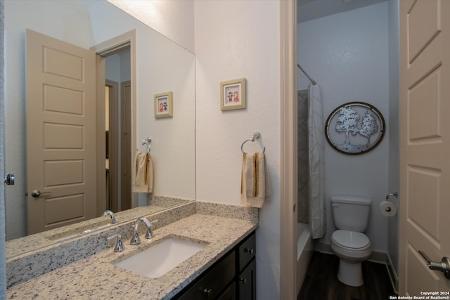 full bathroom with shower / tub combo, vanity, hardwood / wood-style flooring, and toilet