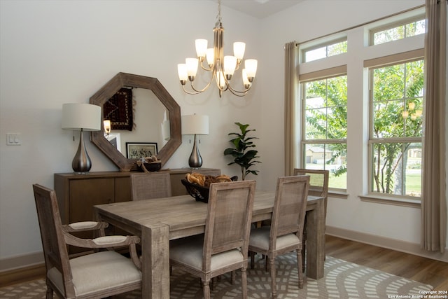 dining area featuring a chandelier and light hardwood / wood-style flooring