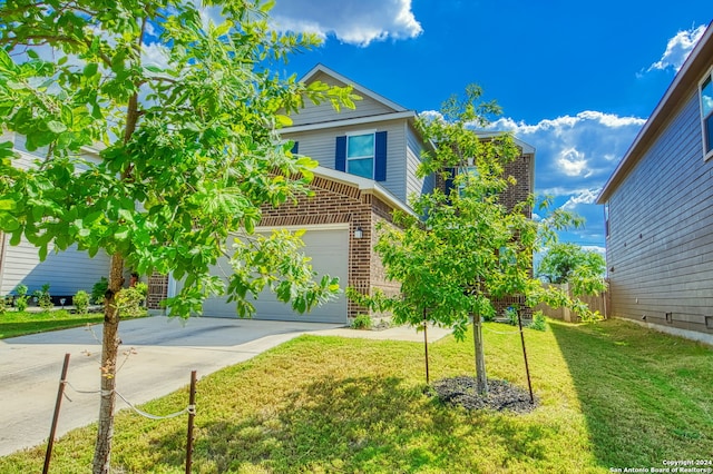 view of front of home featuring a garage and a front yard