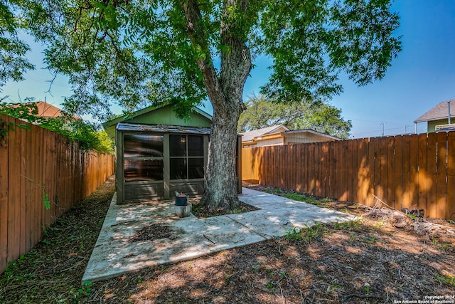 125 Forrest Ave, San Antonio, TX 78204 - fenced backyard featuring a sunroom and a patio