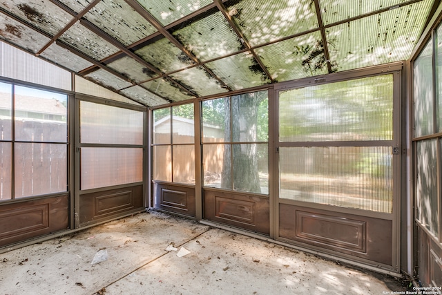 unfurnished sunroom with lofted ceiling