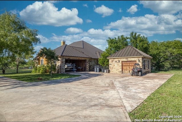 exterior space featuring a garage and a front lawn