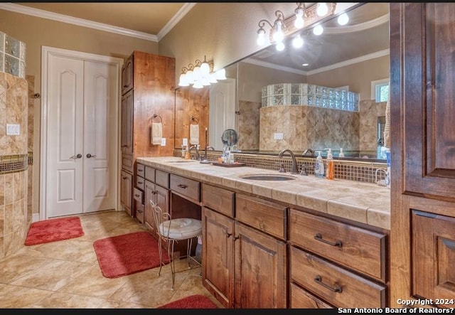 bathroom with tile patterned flooring, vanity, tasteful backsplash, and ornamental molding