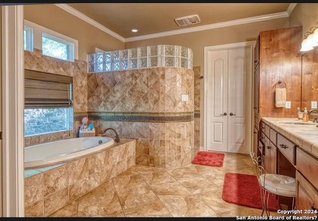 bathroom with vanity, a relaxing tiled tub, and ornamental molding