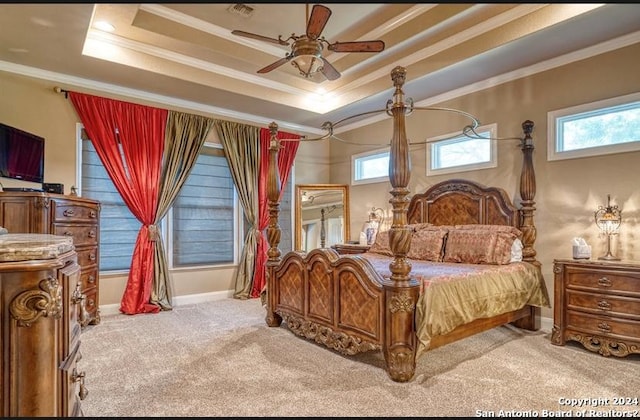 bedroom with light colored carpet, a raised ceiling, ceiling fan, and crown molding