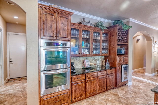 kitchen with stainless steel appliances, wine cooler, crown molding, dark stone counters, and decorative backsplash