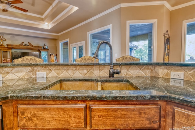 interior space featuring backsplash, ceiling fan, sink, and ornamental molding