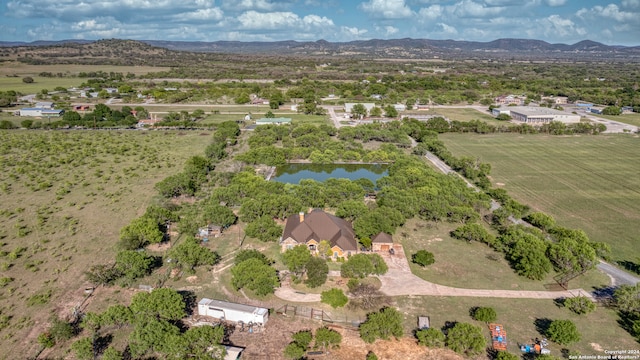 aerial view featuring a water and mountain view and a rural view