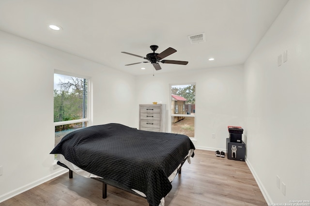 bedroom with ceiling fan and light wood-type flooring