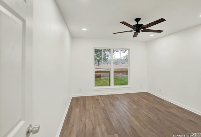 spare room featuring light hardwood / wood-style floors and ceiling fan