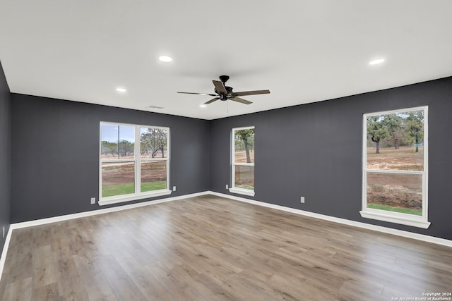 unfurnished room with ceiling fan and light hardwood / wood-style flooring