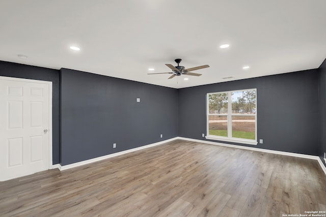 spare room with ceiling fan and light hardwood / wood-style floors