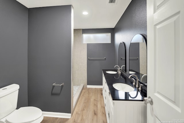 bathroom with hardwood / wood-style floors, vanity, and toilet