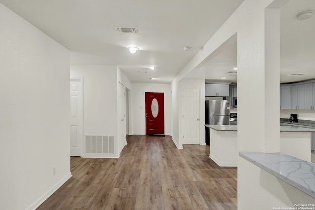 entryway with light hardwood / wood-style floors