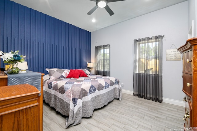 bedroom with light hardwood / wood-style floors and ceiling fan