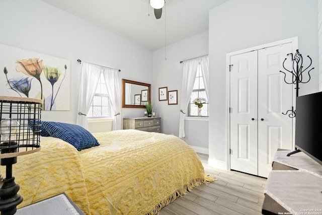 bedroom featuring multiple windows, ceiling fan, and a closet