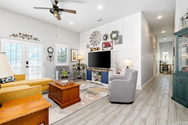 living room featuring french doors and ceiling fan