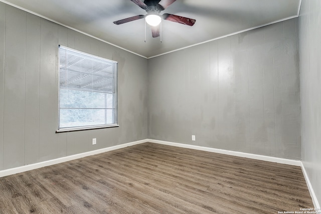 unfurnished room with crown molding, ceiling fan, and wood-type flooring