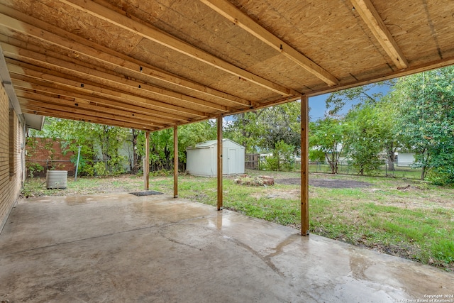 view of patio with central AC and a storage shed