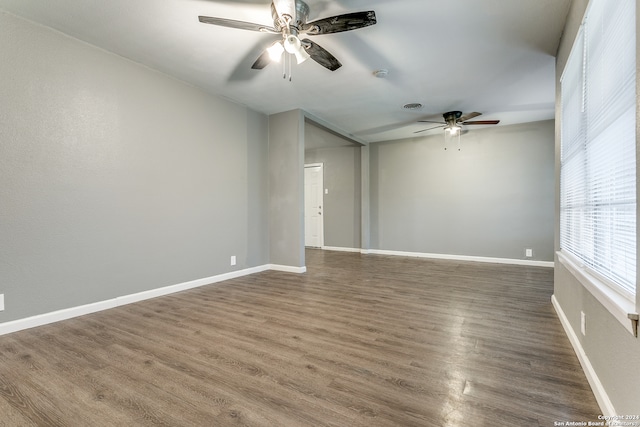 unfurnished room featuring dark hardwood / wood-style floors and ceiling fan