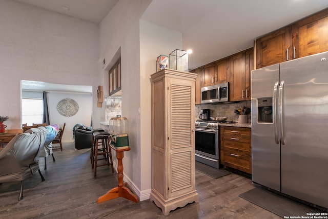 kitchen with decorative backsplash, dark hardwood / wood-style floors, and appliances with stainless steel finishes