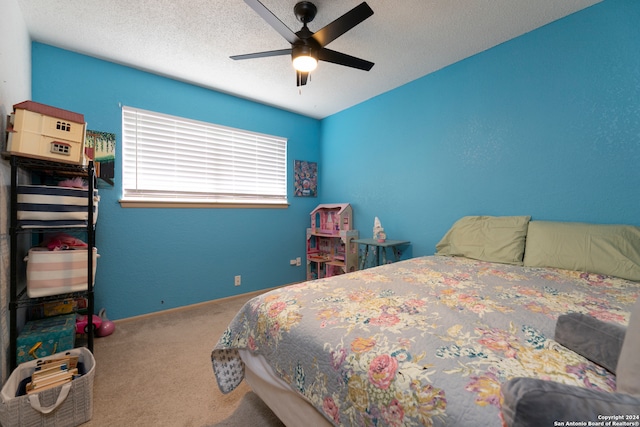 bedroom featuring carpet, a textured ceiling, and ceiling fan