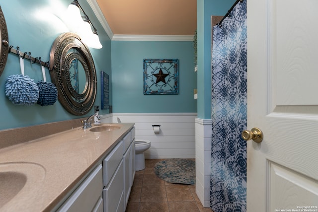 bathroom featuring tile patterned flooring, vanity, toilet, and crown molding