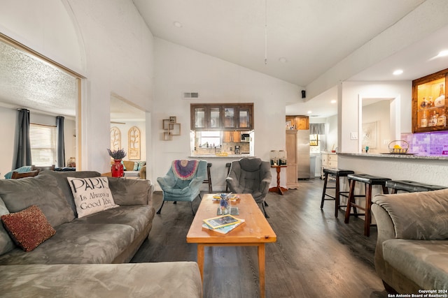 living room with dark hardwood / wood-style floors and high vaulted ceiling