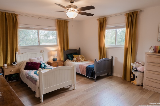 bedroom with ceiling fan and light wood-type flooring