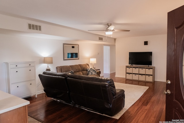 living room featuring dark hardwood / wood-style flooring and ceiling fan