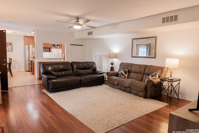 living room featuring ceiling fan and hardwood / wood-style floors