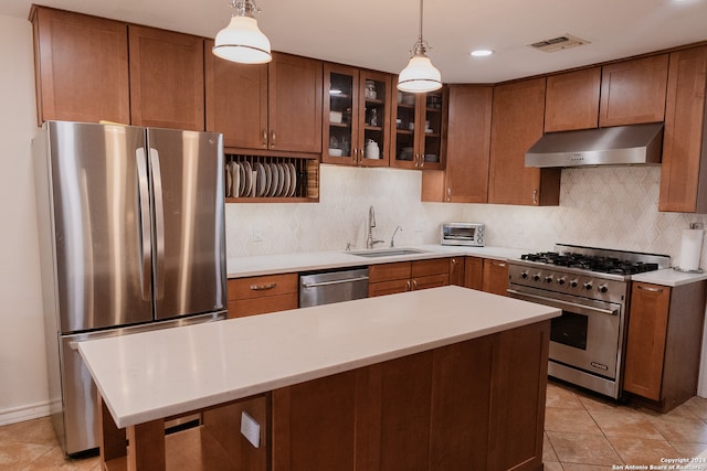 kitchen with light tile patterned flooring, stainless steel appliances, hanging light fixtures, and sink