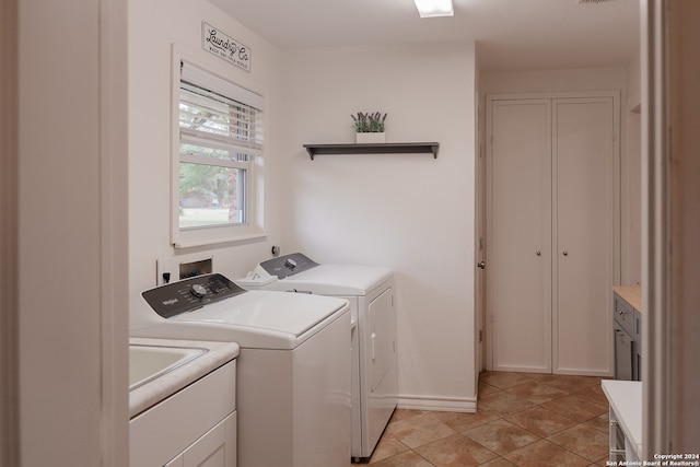 washroom featuring washer and clothes dryer and light tile patterned floors