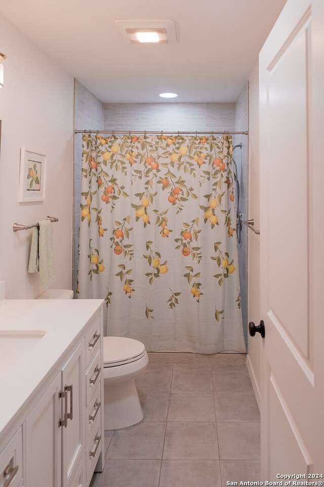 bathroom with tile patterned floors, vanity, and toilet